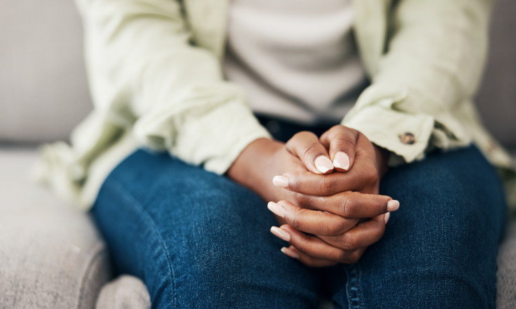 a woman sat with her hands together