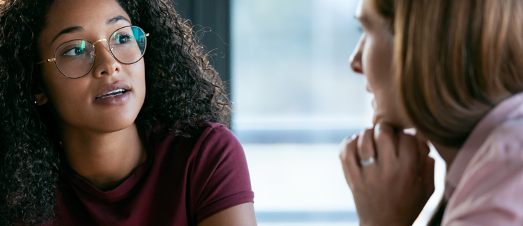 About Us feature box image of two woman talking